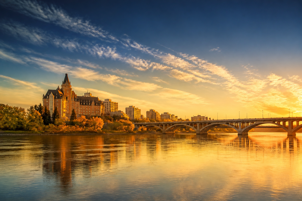 Saskatoon river skyline at sunset with the Bessborough Hotel and Broadway Bridge YXE Marketing web design Saskatoon